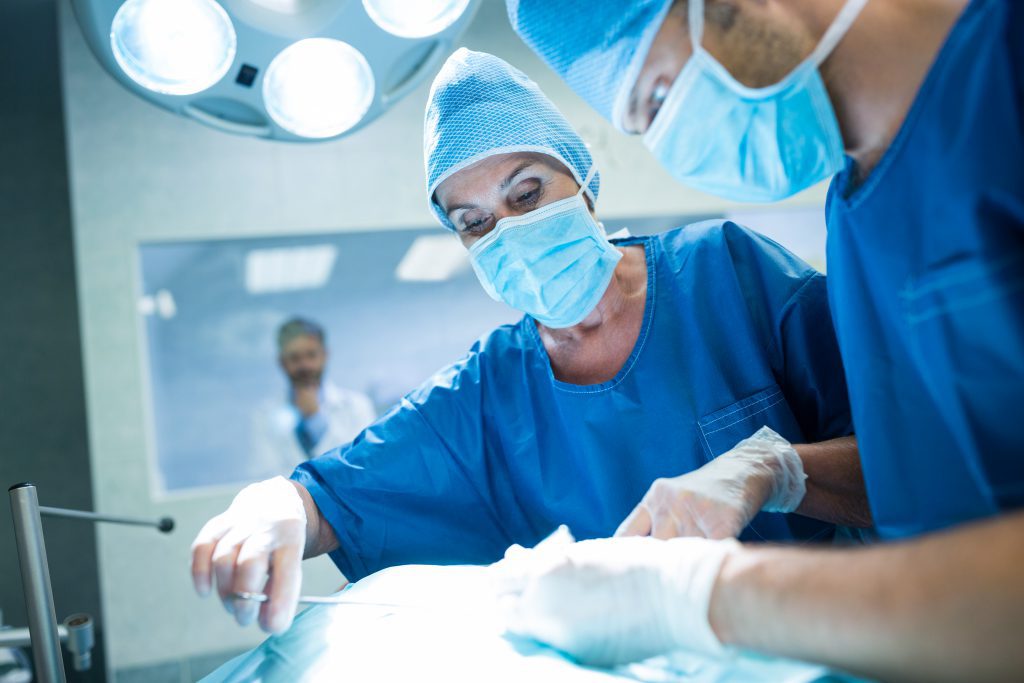 surgeons performing operation operation room